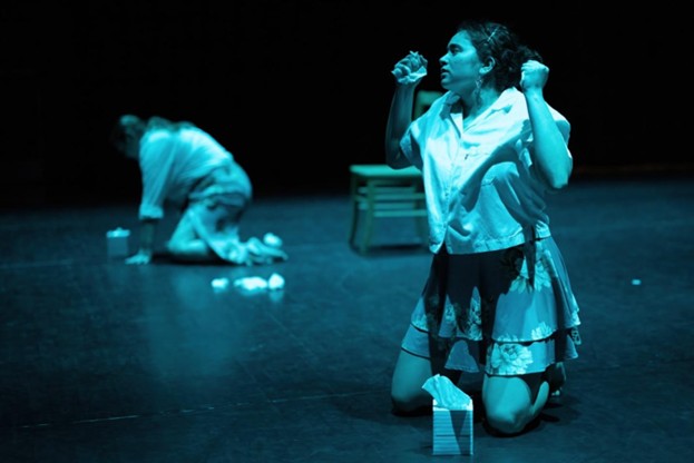 Production photo with woman on knees with box of tissues